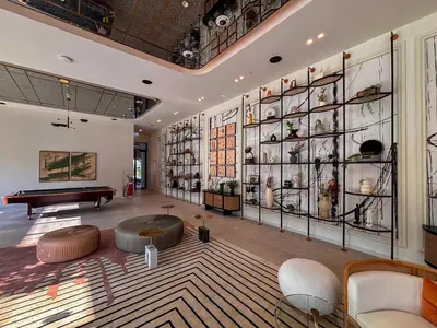 a large room with a pool table and shelves of vases at Frank Porter - Golf Vile in Dubai