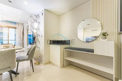 a kitchen with a mirror and a dining room at Unbeatable Rate Modern 2BR with Partial Canal Views by Deluxe Holiday Homes in Dubai