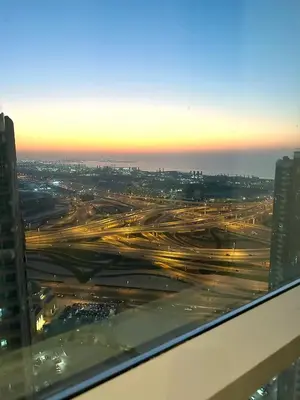 a view of a city at night from a building at Stunning Studio with Sea-View in Jumeirah Lake Towers JLT in Dubai