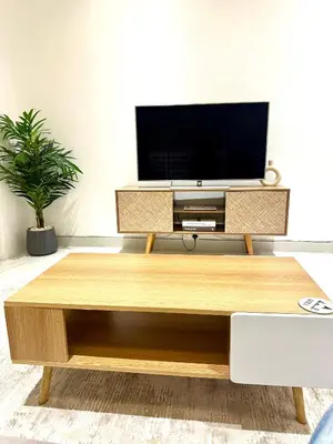 a living room with a tv on a wooden coffee table at Stunning Studio with Sea-View in Jumeirah Lake Towers JLT in Dubai
