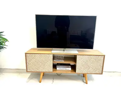 a tv sitting on top of a wooden entertainment center at Stunning Studio with Sea-View in Jumeirah Lake Towers JLT in Dubai