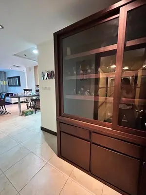 a large glass cabinet in a room with a table at Click Stay - JLT - 2 Bedroom & Balcony Lakes view Entire Apartment -AZ in Dubai
