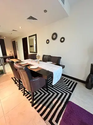 a dining room with a table and chairs on a rug at Click Stay - JLT - 2 Bedroom & Balcony Lakes view Entire Apartment -AZ in Dubai