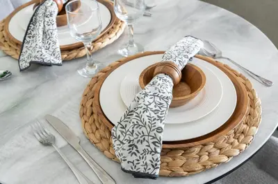 a table with plates and napkins on top of a table at Chic JLT Studio Lake View Metro 5min Marina in Dubai