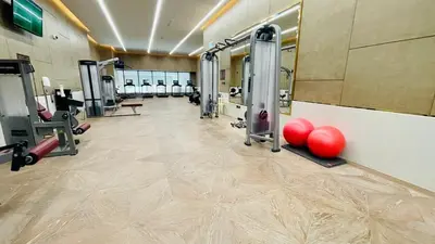 a gym with red balls on the floor and machines at LUX Iconic Views at The Palm Tower Suite 5 in Dubai