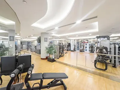 a gym with treadmills and machines in a room at Burj Khalifa & Fountain From Your Balcony Near Dubai Mall & Metro in Dubai