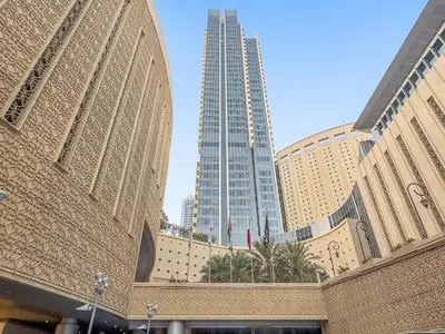 a building with two tall buildings in the background at Burj Khalifa & Fountain From Your Balcony Near Dubai Mall & Metro in Dubai