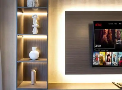 a book shelf with a vase and a tv at Palm & Sea View 2BR JBR Beach Oasis 1 in Dubai