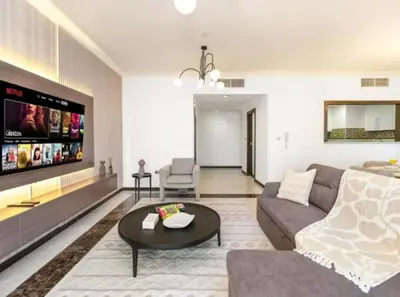 a living room with a couch and a table at Palm & Sea View 2BR JBR Beach Oasis 1 in Dubai