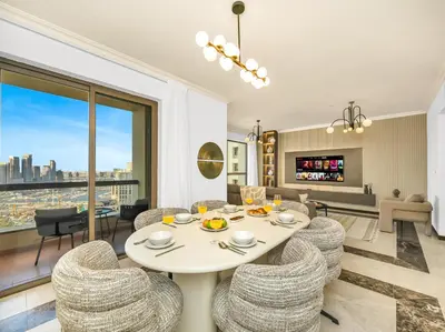 a living room with a white table and chairs at Palm & Sea View 2BR JBR Beach Oasis 1 in Dubai