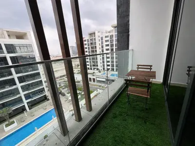 a balcony with a table and a bench on a building at Spacious Comfortable Apartment for your Family or you Group in Dubai