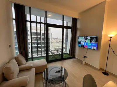a living room with a couch and a glass table at Spacious Comfortable Apartment for your Family or you Group in Dubai