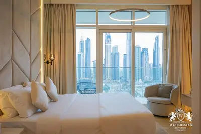a hotel room with a bed and a large window at Westminster Beach Front in Dubai
