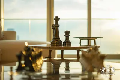 two chess pieces on a table in a living room at Westminster Beach Front in Dubai