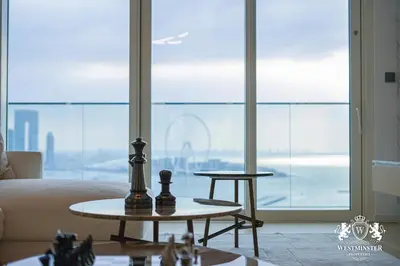 a living room with a table with chess pieces on it at Westminster Beach Front in Dubai
