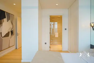a bedroom with a bed and a hallway at Westminster Beach Front in Dubai