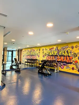 a gym with several tread machines in a room at Luxury Burj Khalifa & Canal View Apartment, Business Bay, Downtown Dubai in Dubai
