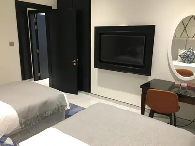 a bedroom with a bed and a desk and a mirror at Two Bedroom apartment in Millennium Atra Business Bay Dubai in Dubai
