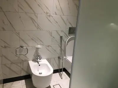 a white bathroom with a sink and a toilet at Two Bedroom apartment in Millennium Atra Business Bay Dubai in Dubai