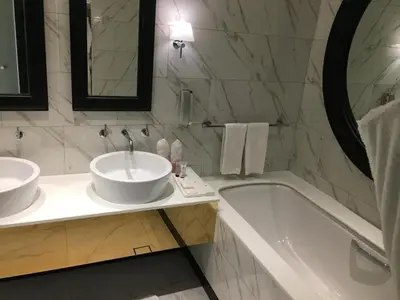 a bathroom with two sinks and a bath tub at Two Bedroom apartment in Millennium Atra Business Bay Dubai in Dubai