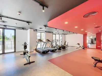 a gym with treadmills and exercise equipment in a room at La Sirene 3 - Elegant Two Bedroom in Jumeirah 1 in Dubai