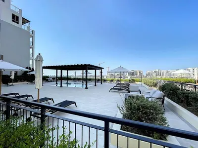 a pool with chairs and a pavilion on a balcony at La Sirene 3 - Elegant Two Bedroom in Jumeirah 1 in Dubai