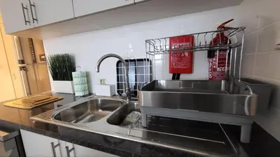 a kitchen with a sink and a counter top at Modern 2BR -5min to Metro-Unit 211 in Dubai