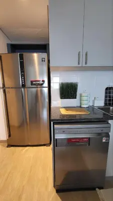 a kitchen with a stainless steel refrigerator and a counter at Modern 2BR -5min to Metro-Unit 211 in Dubai