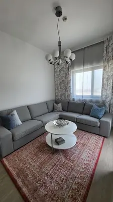 a living room with a couch and a table at Modern 2BR -5min to Metro-Unit 211 in Dubai