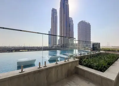 a building with a swimming pool with a view of the city at Sophisticated Studio Escape Luxury Design in Dubai