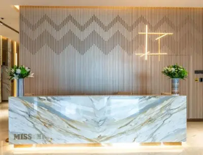 a lobby with a marble counter and a cross on the wall at Sophisticated Studio Escape Luxury Design in Dubai