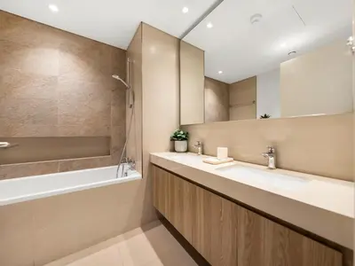 a bathroom with two sinks and a tub and a mirror at The Cinema Suite Luxury 2-Bed Near Dubai Mall in Dubai