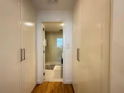 a hallway with white doors and a bathroom at Opulent Flat with Beach, Pool & Canal View in JBR in Dubai