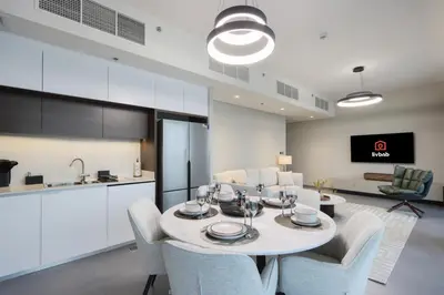 a kitchen and dining room with a table and chairs at Waterfront 2BR with Dubai Skyline Views in Dubai