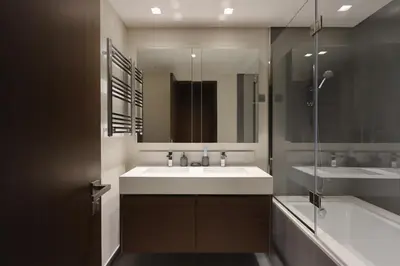 a bathroom with a sink and a large mirror at Waterfront 2BR with Dubai Skyline Views in Dubai