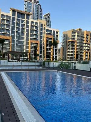 a swimming pool in front of some tall buildings at Brand New Studio Near Burj khalifa & Dubai Mall in Dubai