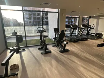 a gym with treadmills and ellipticals in a building at Brand New Studio Near Burj khalifa & Dubai Mall in Dubai