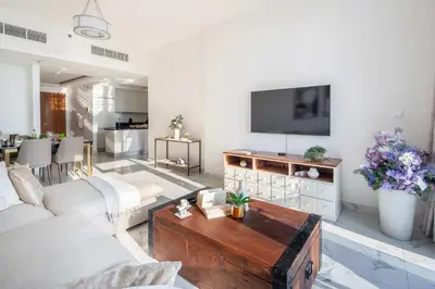 a living room with a couch and a tv at Frank Porter - Amna Tower in Dubai