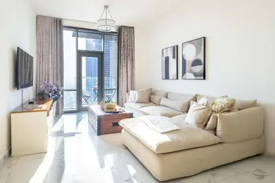 a living room with two couches and a large window at Frank Porter - Amna Tower in Dubai
