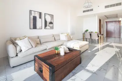 a living room with a couch and a coffee table at Frank Porter - Amna Tower in Dubai