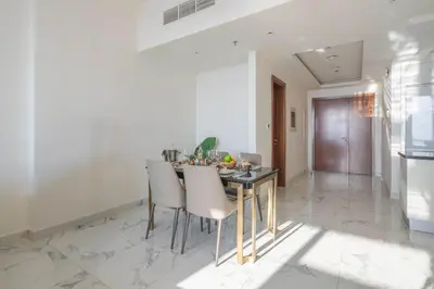 a kitchen and dining room with a table and chairs at Frank Porter - Amna Tower in Dubai