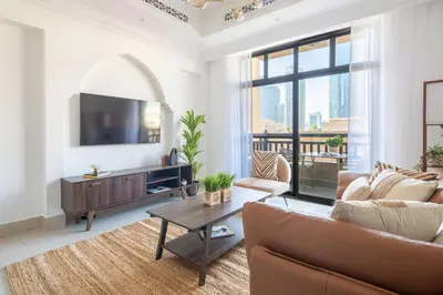 a living room with a couch and a tv at Frank Porter - Tajer Tower E in Dubai