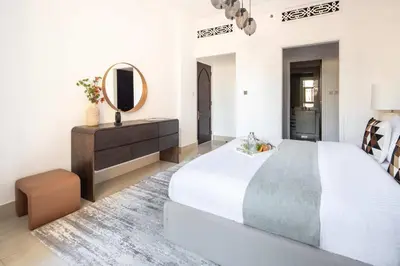 a bedroom with a large bed and a mirror at Frank Porter - Tajer Tower E in Dubai