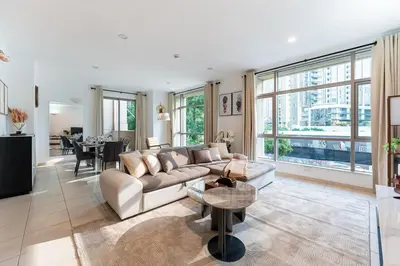 a living room with a couch and a table at Chic 1-Bedroom Getaway with Downtown Living Charm in Dubai