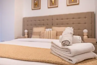 a pile of towels sitting on top of a bed at Chic 1-Bedroom Getaway with Downtown Living Charm in Dubai
