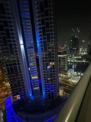 a view from the top of a building at night at Elite Residence business bay Downtown Dubai in Dubai