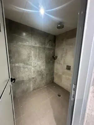 a bathroom with a shower with a glass door at Elite Residence business bay Downtown Dubai in Dubai