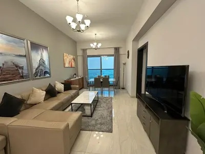 a living room with a couch and a flat screen tv at Elite Residence business bay Downtown Dubai in Dubai