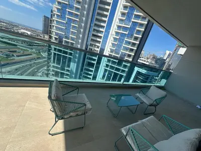a balcony with chairs and tables and large windows at Elite Residence business bay Downtown Dubai in Dubai