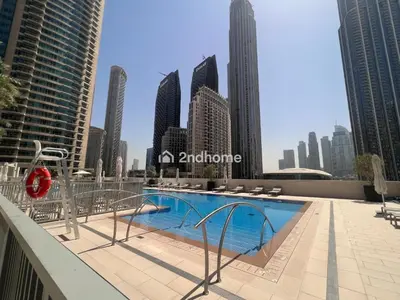 a swimming pool on the roof of a building with a city at Unit Overlooking Burj Khalifa and Fountain View in Dubai